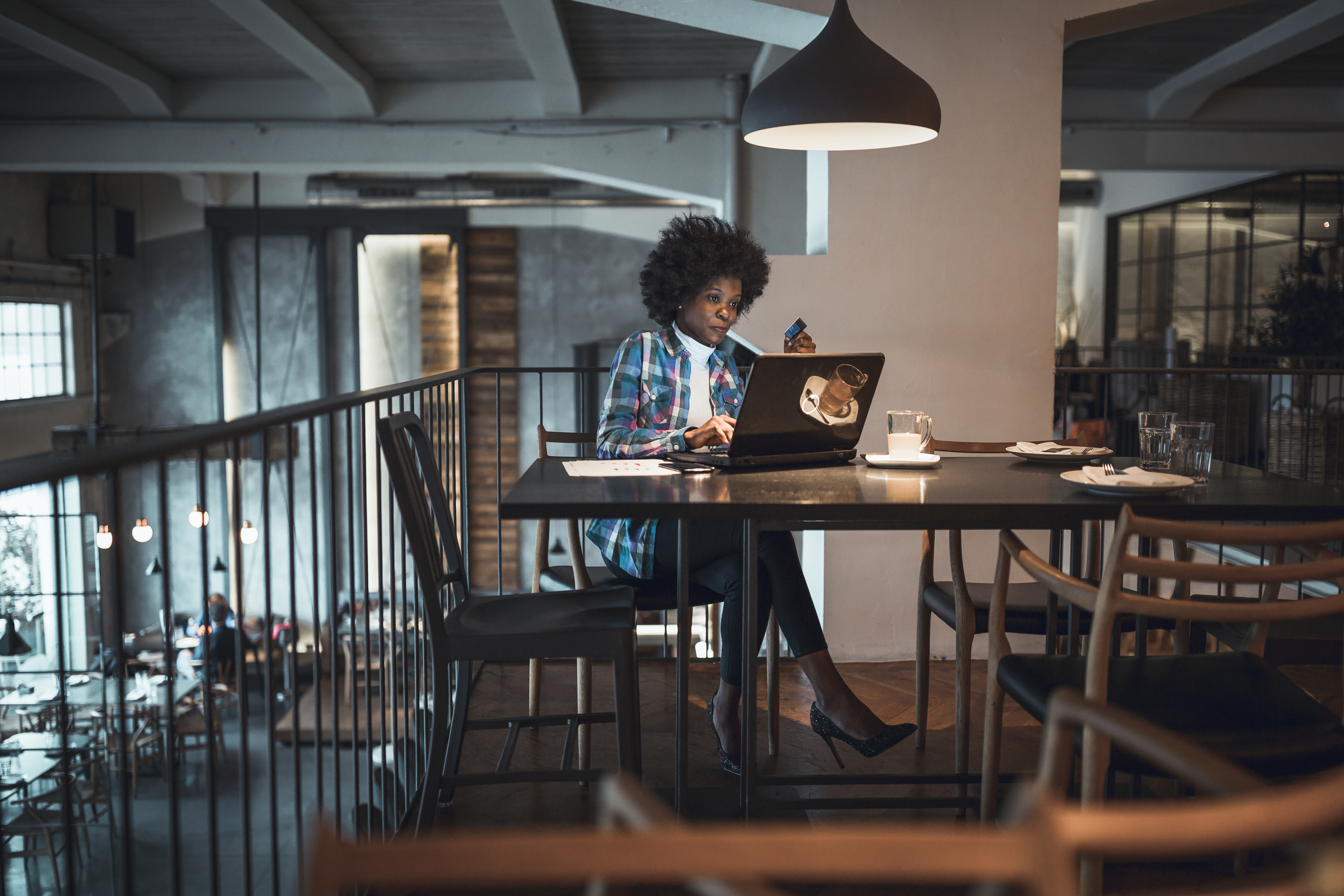 woman-writing-on-laptop-in-empty-coffeeshop